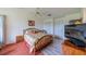 Bedroom featuring a bed, ceiling fan, and television at 1618 Nantucket Dr, Sun City Center, FL 33573