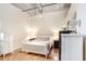 Bright bedroom features white furniture, polished concrete floors, and an exposed ductwork ceiling at 175 2Nd S St # 1014, St Petersburg, FL 33701
