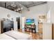 Bright bedroom features white furniture, polished concrete floors, and an exposed ductwork ceiling at 175 2Nd S St # 1014, St Petersburg, FL 33701