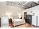 Bright bedroom features white furniture, polished concrete floors, and an exposed ductwork ceiling at 175 2Nd S St # 1014, St Petersburg, FL 33701