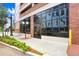Attractive building entrance with large windows, brick accents, manicured landscaping, and vintage lighting at 175 2Nd S St # 1014, St Petersburg, FL 33701