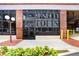 Attractive building entrance with large windows, brick accents, manicured landscaping, and vintage lighting at 175 2Nd S St # 1014, St Petersburg, FL 33701