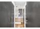 Hallway view with closet and bathroom with natural wood vanity, custom mirror, and lighting at 175 2Nd S St # 1014, St Petersburg, FL 33701