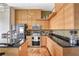 Modern kitchen featuring stainless steel appliances, a tile backsplash, granite countertops, and hardwood floors at 175 2Nd S St # 1014, St Petersburg, FL 33701