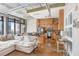 Open living area with a modern kitchen, comfortable sofa, and industrial-style elements at 175 2Nd S St # 1014, St Petersburg, FL 33701