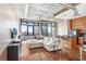 Bright open-concept living space with a large sofa, industrial-style ceilings, and a modern kitchen at 175 2Nd S St # 1014, St Petersburg, FL 33701