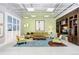 A cozy lounge area with a plush sofa, soft chairs, stylish lighting, and a custom media center at 175 2Nd S St # 1014, St Petersburg, FL 33701
