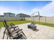 The property features a large grassy backyard with a paved seating area and privacy fence at 17950 Beaming Rays Ln, Lutz, FL 33558