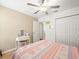 Comfortable bedroom with hardwood floors, white closet doors, and a dressing table at 17950 Beaming Rays Ln, Lutz, FL 33558