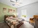 Comfortable bedroom with natural light, soft carpet and calming green accent wall at 17950 Beaming Rays Ln, Lutz, FL 33558