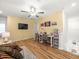 Upstairs bonus room featuring a ceiling fan, television, couch, and work space at 17950 Beaming Rays Ln, Lutz, FL 33558