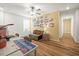 Bright bonus room features a Gathering photo wall, seating area, and a convenient workspace at 17950 Beaming Rays Ln, Lutz, FL 33558