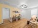 Upstairs bonus room with a ceiling fan, desk for two, and hardwood floors for added appeal at 17950 Beaming Rays Ln, Lutz, FL 33558