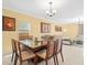 Inviting dining room with modern table set adjacent to a comfortable living space at 17950 Beaming Rays Ln, Lutz, FL 33558