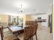 Open-concept layout with dining area flowing into the kitchen and living room at 17950 Beaming Rays Ln, Lutz, FL 33558