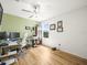 Well-lit home office with hardwood floors, a desk, and a printer for productivity at 17950 Beaming Rays Ln, Lutz, FL 33558