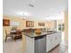 Open kitchen concept featuring an island, stainless dishwasher, and seating at 17950 Beaming Rays Ln, Lutz, FL 33558