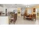 Open floor plan featuring a kitchen with white cabinets and stainless steel appliances at 17950 Beaming Rays Ln, Lutz, FL 33558