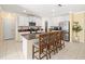 Bright kitchen with granite countertops, an island with seating, and white cabinetry at 17950 Beaming Rays Ln, Lutz, FL 33558