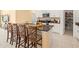 Kitchen island with white cabinets, seating, and granite countertops at 17950 Beaming Rays Ln, Lutz, FL 33558