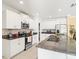 Spacious kitchen with granite countertops, stainless appliances, and white cabinetry at 17950 Beaming Rays Ln, Lutz, FL 33558