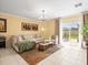 Cozy living room with comfortable seating and view of the outdoor patio at 17950 Beaming Rays Ln, Lutz, FL 33558