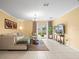 Inviting living room with natural light and access to the outdoor space at 17950 Beaming Rays Ln, Lutz, FL 33558