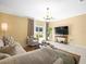 Relaxing living room featuring a sliding glass door with backyard views at 17950 Beaming Rays Ln, Lutz, FL 33558