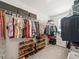 Spacious walk-in closet with ample hanging space and shelving for organized storage at 17950 Beaming Rays Ln, Lutz, FL 33558