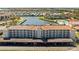 Aerial view of waterfront condos with a pool, covered parking, and well-maintained landscaping at 19029 Us Highway 19 N # 2-17, Clearwater, FL 33764