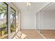Bright bedroom featuring wood floors, sliding glass doors, and a sliding-door closet at 19029 Us Highway 19 N # 2-17, Clearwater, FL 33764