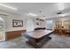 Well-lit billiard room with a large pool table, pendant lighting, and cue rack at 19029 Us Highway 19 N # 2-17, Clearwater, FL 33764