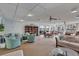 Inviting clubhouse featuring comfortable seating, a bookcase, and expansive windows with waterfront views at 19029 Us Highway 19 N # 2-17, Clearwater, FL 33764
