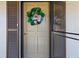 Charming condo door with a decorative wreath, enhancing the welcoming atmosphere at 19029 Us Highway 19 N # 2-17, Clearwater, FL 33764
