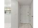 Bright entryway featuring tiled floors, a front door, and a window with blinds at 19029 Us Highway 19 N # 2-17, Clearwater, FL 33764
