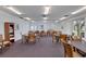 Game room with multiple tables and chairs for playing board games or cards at 19029 Us Highway 19 N # 2-17, Clearwater, FL 33764