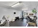 Well-equipped gym with multiple exercise machines, free weights, a treadmill, and a wall-mounted television at 19029 Us Highway 19 N # 2-17, Clearwater, FL 33764