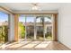 Bright living room featuring wood floors, sliding glass doors, and a ceiling fan at 19029 Us Highway 19 N # 2-17, Clearwater, FL 33764