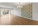 Unfurnished living room with wood-style flooring and sliding glass doors to the balcony at 19029 Us Highway 19 N # 2-17, Clearwater, FL 33764
