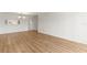 Unfurnished living room with wood-style flooring and a dining area off to the side at 19029 Us Highway 19 N # 2-17, Clearwater, FL 33764