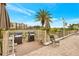 Outdoor grilling area with two grills, table, chairs, and tropical landscaping perfect for entertaining at 19029 Us Highway 19 N # 2-17, Clearwater, FL 33764