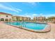 Resort-style pool with plenty of lounge chairs and views of lush landscaping and multiple condo buildings at 19029 Us Highway 19 N # 2-17, Clearwater, FL 33764
