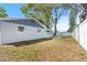 Backyard view of a single-story home surrounded by mature trees at 1972 Sourwood Blvd, Dunedin, FL 34698