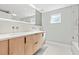 Modern bathroom with double sink vanity, tile accents, and updated finishes at 1972 Sourwood Blvd, Dunedin, FL 34698