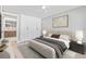Serene bedroom with a king-size bed, minimalist decor, and a view into the ensuite bathroom at 1972 Sourwood Blvd, Dunedin, FL 34698