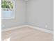 Bedroom with light-colored walls and flooring with a view of the backyard at 1972 Sourwood Blvd, Dunedin, FL 34698