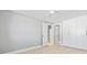 Bedroom with hardwood floors, built-in closet, and doors to an adjoining bathroom at 1972 Sourwood Blvd, Dunedin, FL 34698
