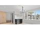 Bright dining area features modern chandelier, mini bar and large windows bringing in natural light at 1972 Sourwood Blvd, Dunedin, FL 34698