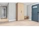 Welcoming entryway with a built-in storage cabinet and a stylish front door at 1972 Sourwood Blvd, Dunedin, FL 34698