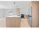 Open-concept kitchen with an island, stainless steel appliances, and modern finishes at 1972 Sourwood Blvd, Dunedin, FL 34698